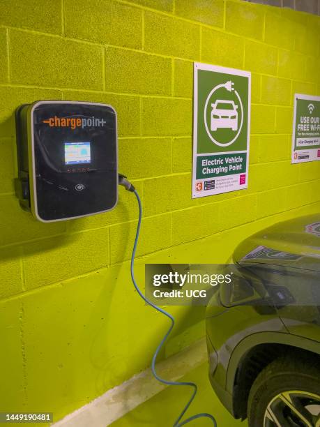 Newbury, Berkshire, England, UK, Electric car battery charging station in an underground car park.