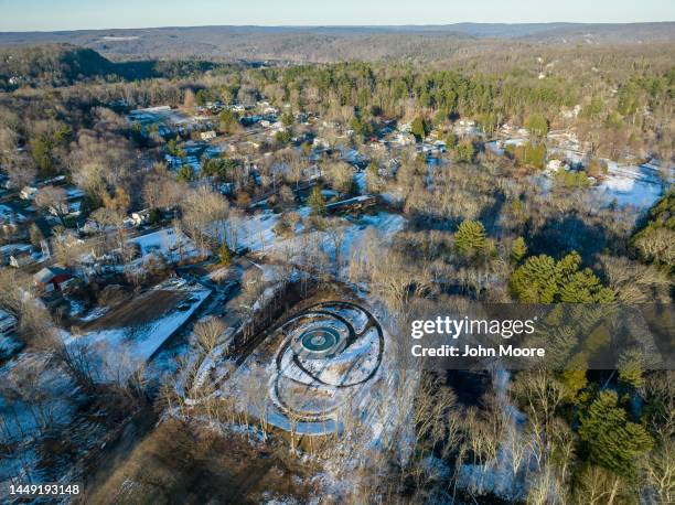 As seen from an aerial view, people visit the Sandy Hook Permanent Memorial on the 10th anniversary of the school shooting on December 14, 2022 in...