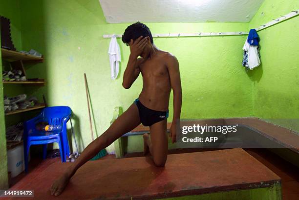 Bryant Ramirez, a 14 year-old cliff diver, stretches before jumping at La Quebrada in Acapulco, Mexico on May 17, 2012. The tradition of 'La...