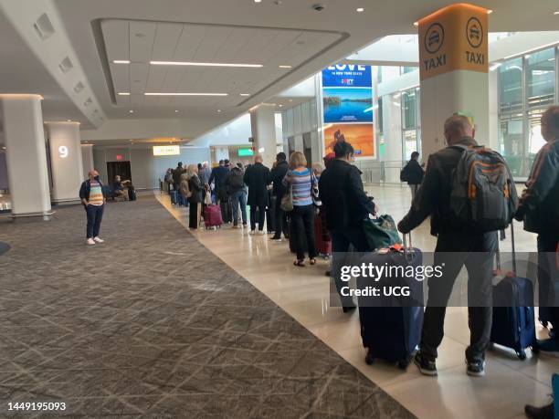 Long line of passengers waiting to get a Taxi from LaGuardia Airport, Queens, New York.
