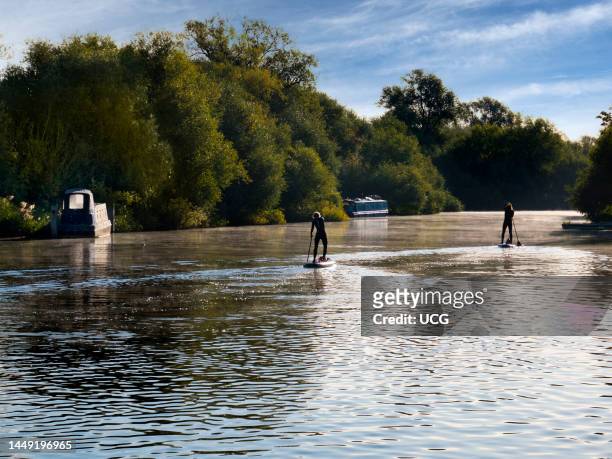 Paddle boarding on the Thames by Abingdon Weir, England.