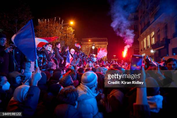 French football fans celebrate on the Champs Elysees after France beat Morocco 2-0 to reach the final of the Fifa World Cup where they will face...