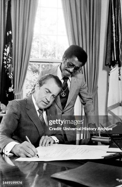 President Richard Nixon with Entertainer Sammy Davis, Jr., new member of Nat'l. Advisory Council on Economic Opportunity, White House, Washington,...