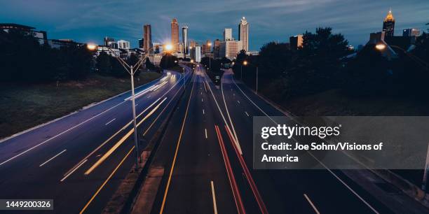 Atlanta Skyline as seen from Jackson Bridge, site of "Walking Dead" TV show, shows speeding cars to skyline.