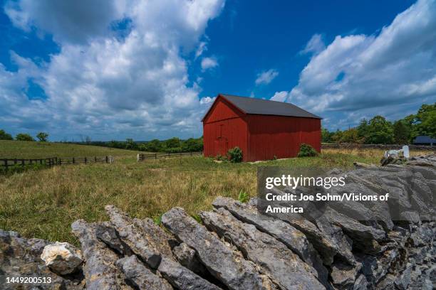 Brightly colored Red Barn and rock stacks outside of Horse District of Lexington, Kentucky.