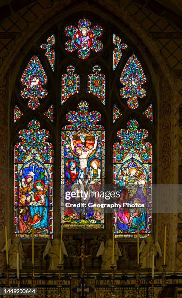 Stained glass window of Crucifixion, Resurrection, Nativity Saint Peter church, Marlborough, Wiltshire, England, UK, Lavers and Barraud.