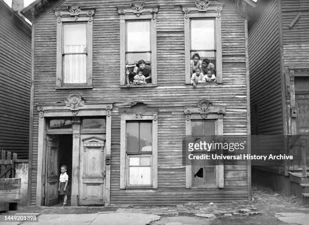 Group of People looking out of windows in rundown House, Chicago, Illinois, USA, Russell Lee, U.S. Office of War Information/U.S. Farm Security...