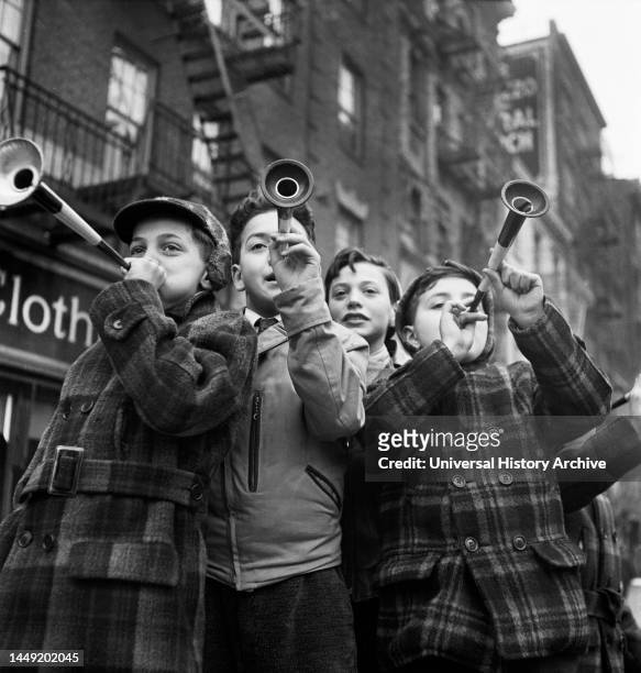 Four Boys blowing horns on New Year's Day, Bleecker Street, New York City, New York, USA, Marjory Collins, U.S. Office of War Information/U.S. Farm...