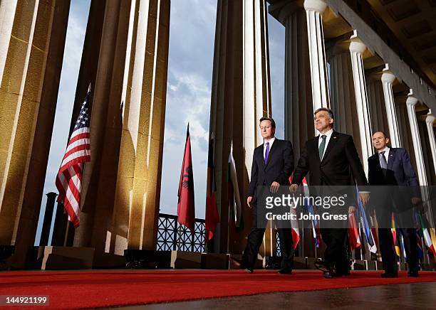British Prime Minister David Cameron Turkish President Abdullah Gul and Slovenian Prime Minister Janez Jansa arrive for a group photo at the NATO...