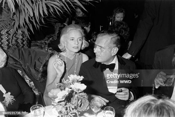 Nancy "Slim" Keith aka Lady Keith and John Richardson attend a charity party at the Carlyle Restaurant in New York City on October 28, 1975.