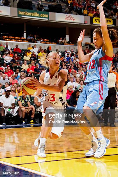 Erin Phillips of the Indiana Fever drives against Laurie Koehn of the Atlanta Dream at Bankers Life Fieldhouse on May 19, 2012 in Indianapolis,...
