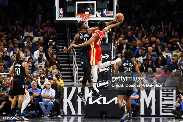 De'Andre Hunter of the Atlanta Hawks looks to shoot as Mo Bamba of the Orlando Magic defends during the fourth quarter at Amway Center on December...