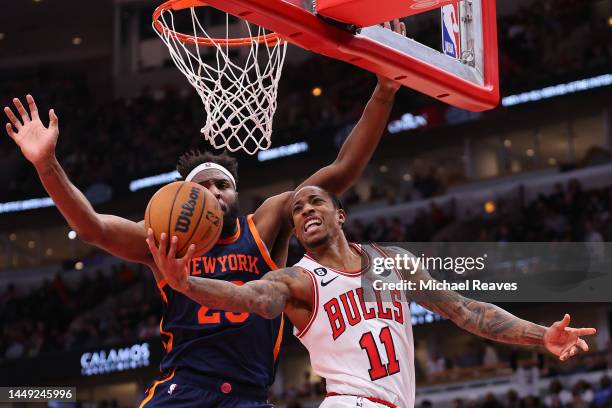 DeMar DeRozan of the Chicago Bulls goes up for a layup against Mitchell Robinson of the New York Knicks during the second half at United Center on...