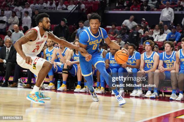 Jaylen Clark of the UCLA Bruins dribbles by Donta Scott of the Maryland Terrapins in the second half during a college basketball game at the Xfinity...