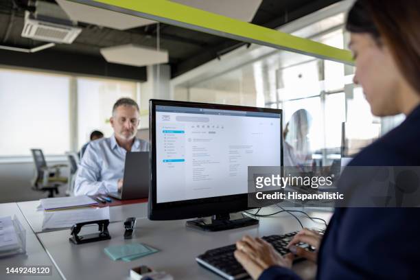 business woman working on her computer at the office - inbox stock pictures, royalty-free photos & images