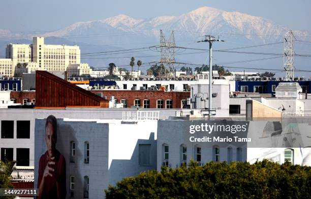 The snowcapped San Gabriel Mountains are visible beyond downtown Los Angeles on December 14, 2022 in Los Angeles, California. A recent storm which...