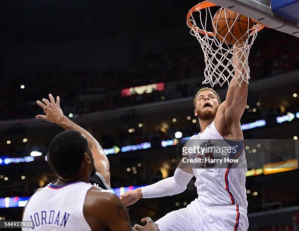 Blake Griffin of the Los Angeles Clippers dunks the ball over Tim Duncan of the San Antonio Spurs in the third quarter in Game Four of the Western...