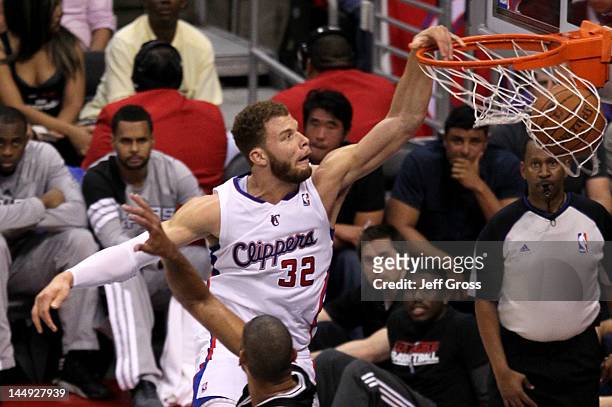 Blake Griffin of the Los Angeles Clippers dunks the ball over Tim Duncan of the San Antonio Spurs in the third quarter in Game Four of the Western...