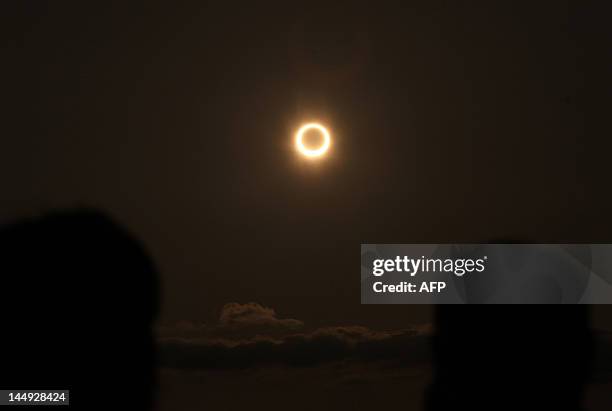 The annular solar eclipse is seen from the coast of Xiamen, in China's southeast province of Fujian on May 21, 2012. Millions turned their eyes to...