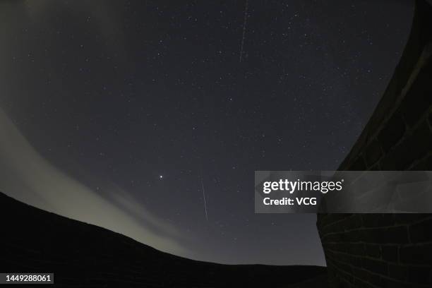 Meteor of Geminid meteor shower streaks across the night sky over the Jinshanling Great Wall on December 14, 2022 in Chengdu, Hebei Province of China.