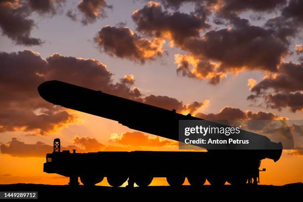 topol-m intercontinental ballistic missile on the background of sunset - intercontinental ballistic missile stock pictures, royalty-free photos & images