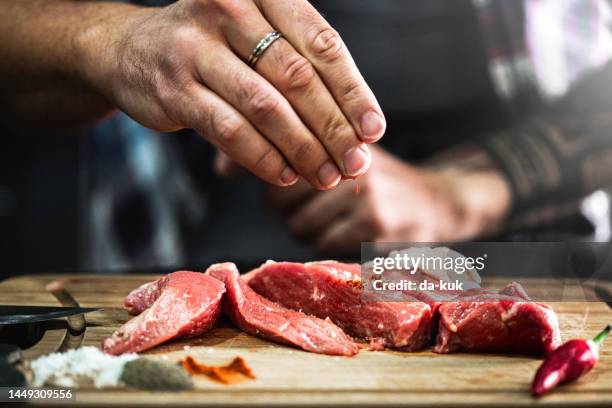 preparing fresh beef slices with spices ready to cook - cut of meat stock pictures, royalty-free photos & images