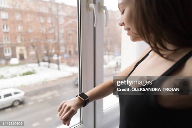 young woman hand with smartwatch close-up - window display stock-fotos und bilder