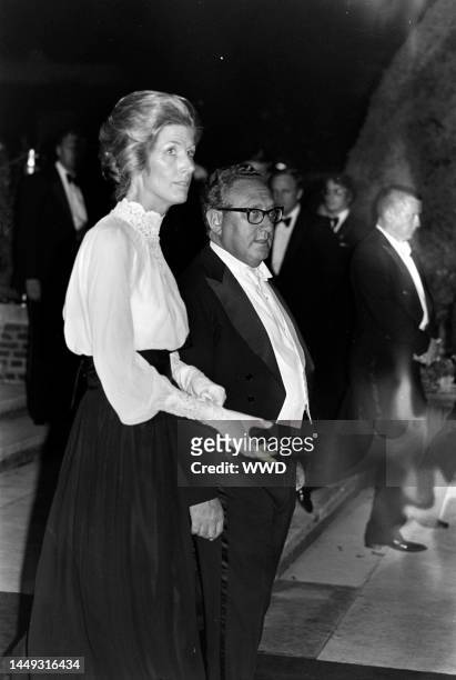 Nancy Kissinger and Henry Kissinger attend a party at the British embassy in Washington, D.C., on July 8, 1976.