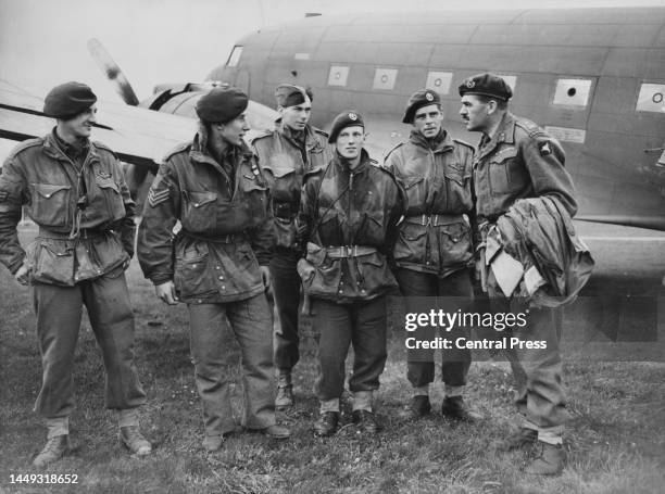Major-General Roy Urquhart , General Officer Commanding the British 1st Airborne Division greets glider pilots Staff-Sergeant John Bonome, Sergeant...