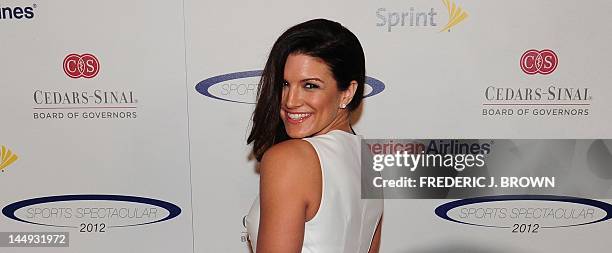 Actress and mixed martial arts fighter Gina Carano poses on arrival for the 27th annual Sports Spectacular in Los Angeles on May 20, 2012 in...