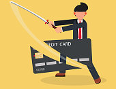 Businessman cutting a Credit Card with Sword.