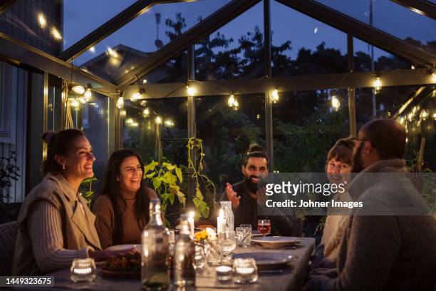 friends having meal in greenhouse - reunião de amigos imagens e fotografias de stock