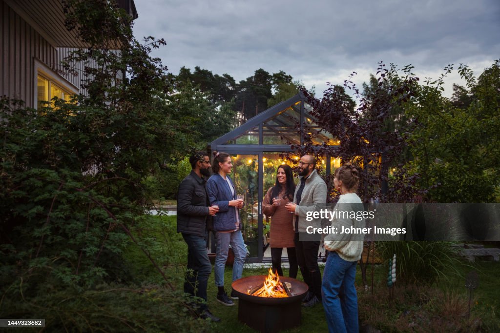 Happy friends talking in garden