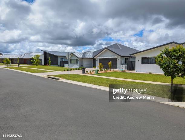 new houses on street suburb clouds - new pavement stock pictures, royalty-free photos & images