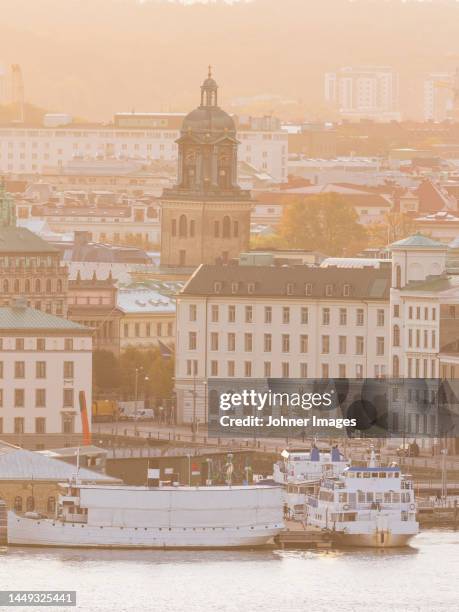 ferries moored, city buildings in background - gothenburg stock pictures, royalty-free photos & images