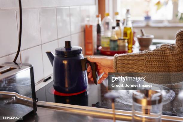 woman preparing coffee in kitchen - electric stove burner ストックフォトと画像