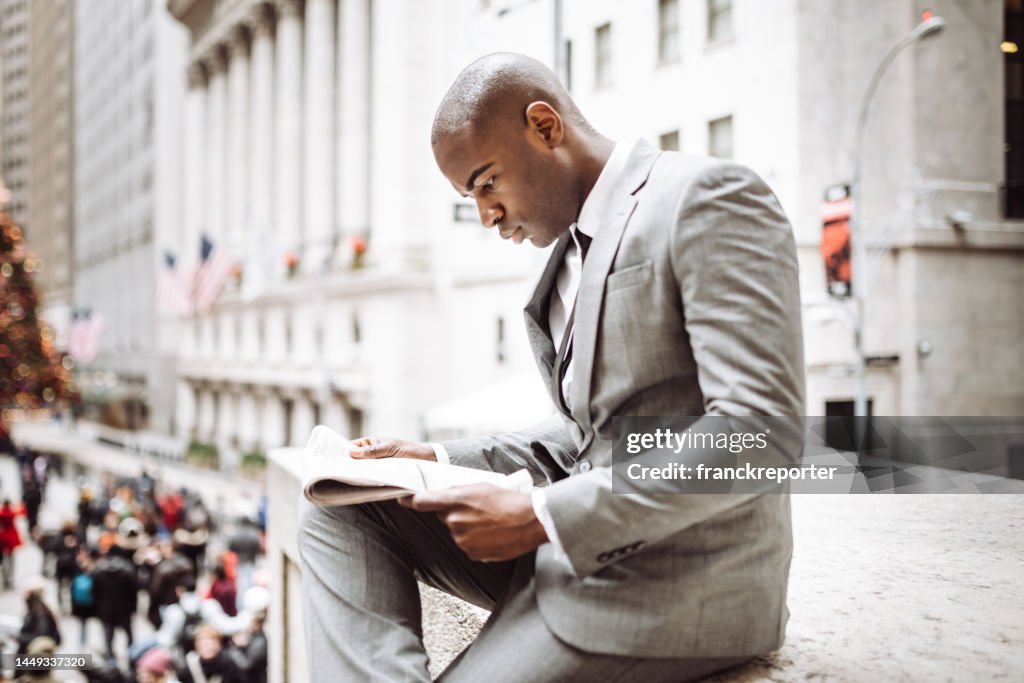 Business man worried reading news in wall street