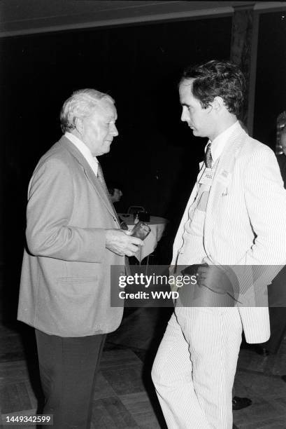 James "Scotty" Reston and Nelson Strobridge "Strobe" Talbott III attend a party in Kansas City, Missouri, on August 16, 1976.