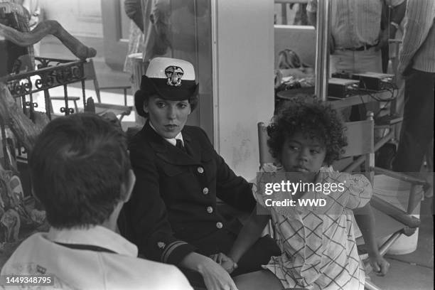 Tyne Daly and daughter Kathryne Dora Brown await filming during production of the TV movie "The Entertainer" in Los Angeles on August 8, 1975.