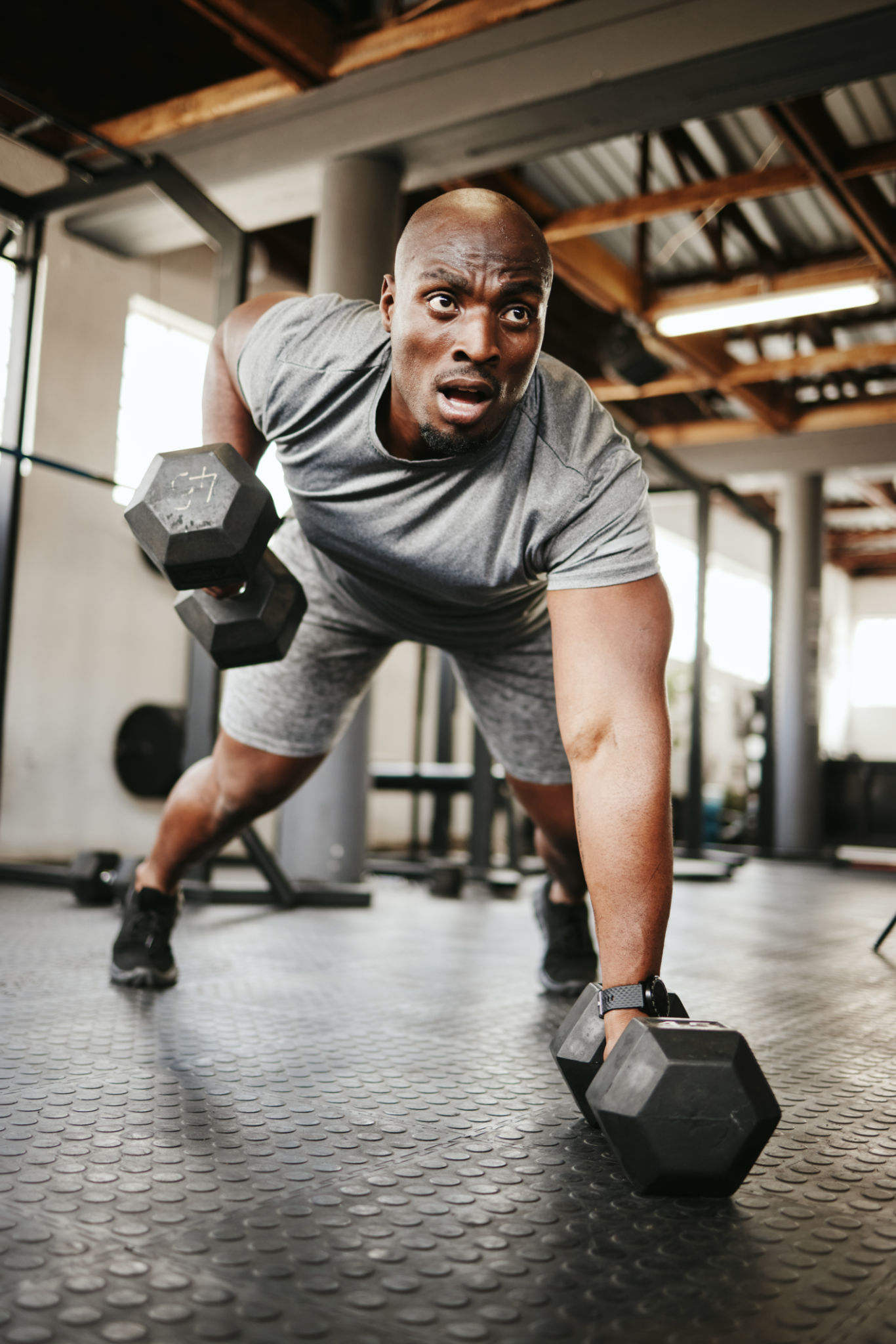 Fitness, gym and black man doing a workout with weights for strength, wellness and training. Bodybuilder, sports and strong African athlete doing push up exercise in a sport, health and active studio Fitness, gym and black man doing a workout with weights for strength, wellness and training. Bodybuilder, sports and strong African athlete doing push up exercise in a sport, health and active studio