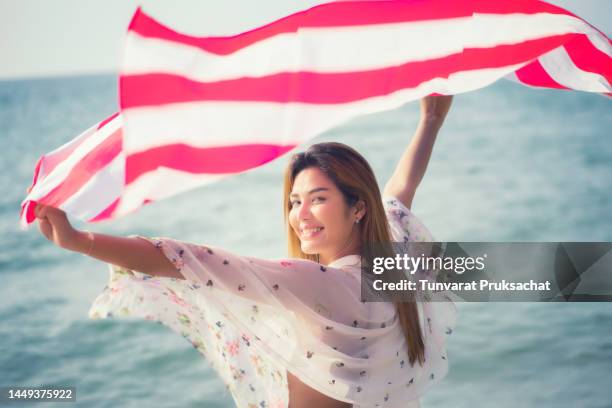 asian woman with american flag , - asian flags ストックフォトと画像