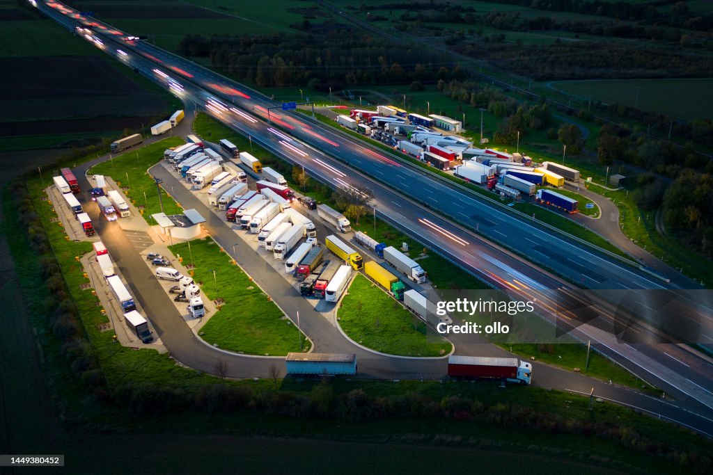 Highway and rest area at dusk - aerial view