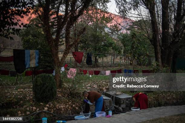 Tibetan nuns wash clothing in a stream running through the grounds of the Dolma Ling Nunnery on December 15, 2022 in Dharamshala, India. Dharamshala,...