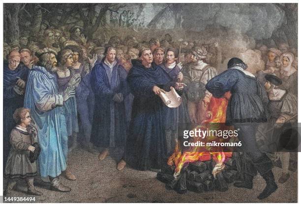old engraving illustration of of martin luther burns the papal bull in wittenberg - martin luther reformation luther stock pictures, royalty-free photos & images