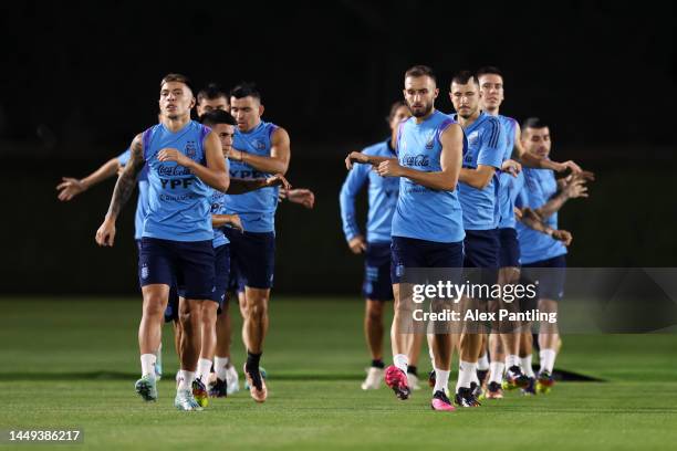 Lisandro Martinez, German Pezzella and Guido Rodriguez of Argentina train during the Argentina training session ahead of the World Cup Final match...