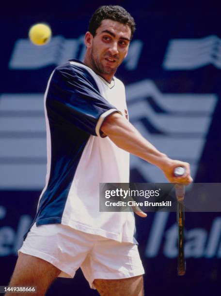 Albert Costa from Spain keeps his eyes on the tennis ball playing a backhand return to Richard Krajicek of the Netherlands during their Men's Singles...