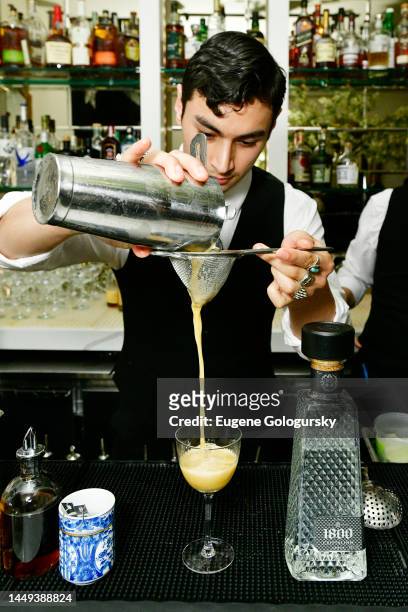 View of a bartender mixing a drink at the 1800 Tequila VIP holiday dinner hosted by Greg Yuna at Mister French on December 14, 2022 in New York City.