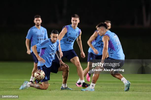 Angel Di Maria and Juan Foyth of Argentina train during the Argentina training session ahead of the World Cup Final match against France at Qatar...