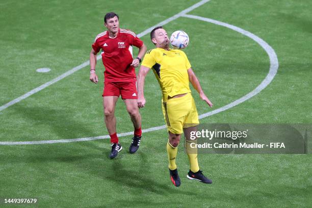 John Terry of European Wolves controls the ball under pressure from Javier Zanetti of South American Panthers during the FIFA Legends Cup match...