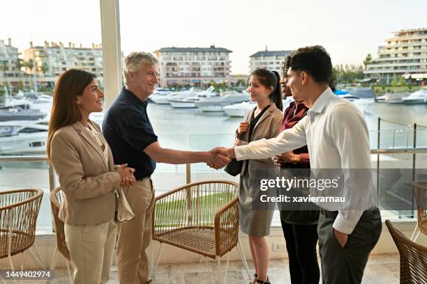 businesspeople meeting in restaurant and shaking hands - happy colleagues doing team building activity imagens e fotografias de stock